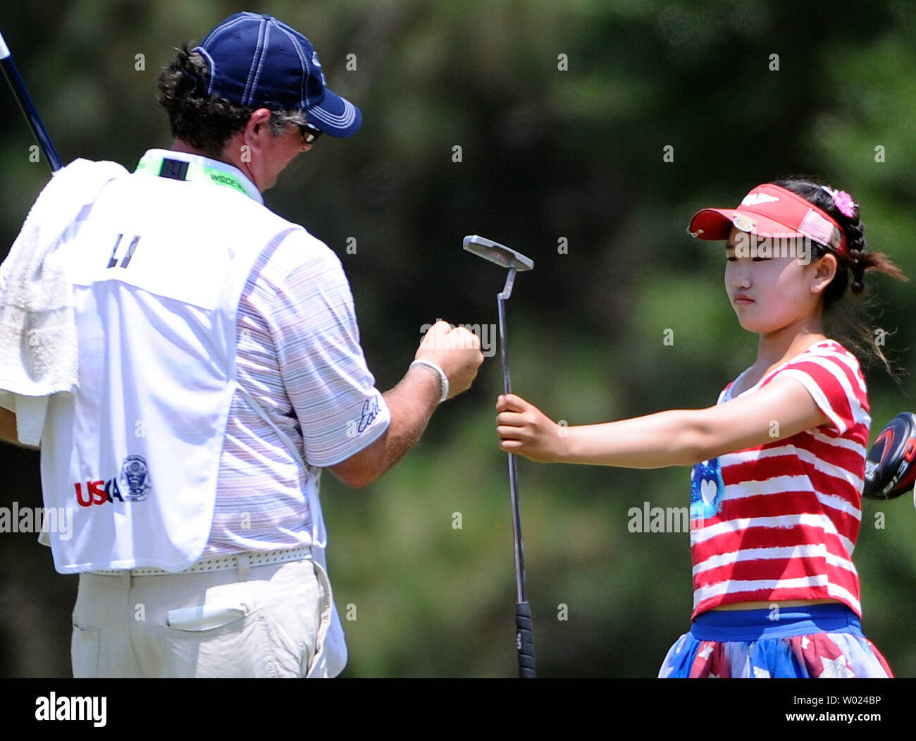 Amateur Lucy Li fist bumps her caddie after putting for a par on hole