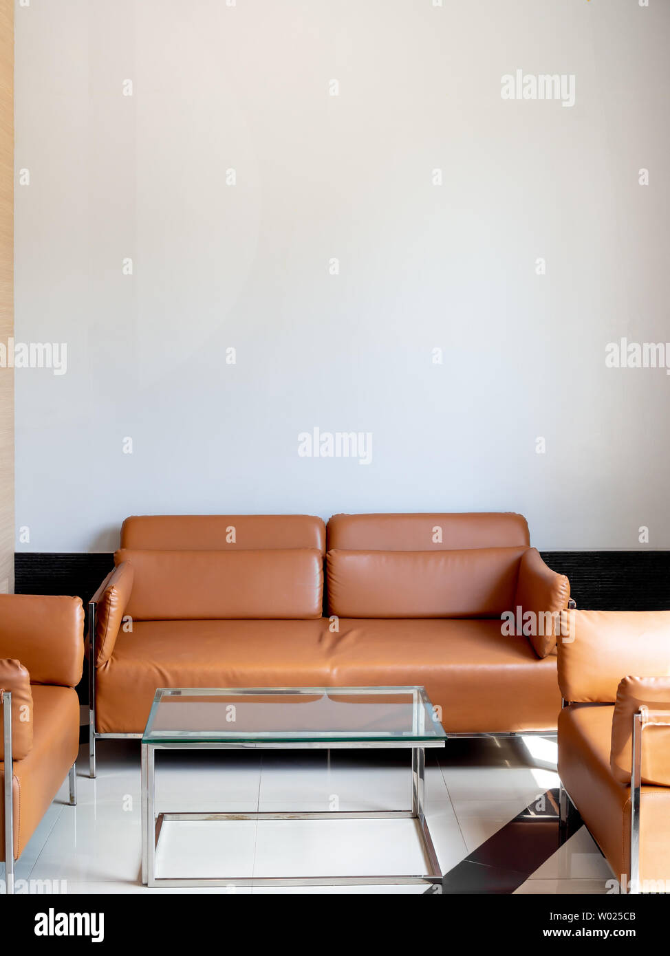 Modern orange leather sofa with glass table on white background with