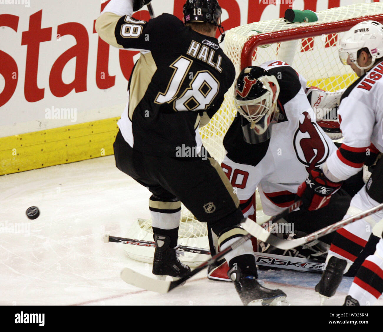 New Jersey Devils goalie Martin Brodeur stops Pittsburgh Penguins Adam