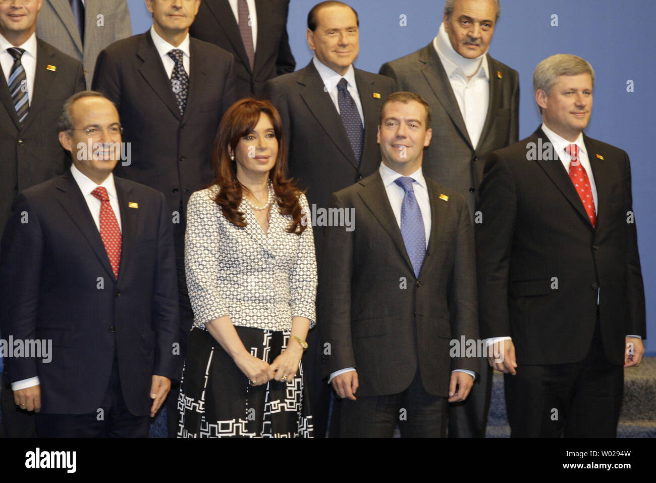 Russian President Dmitry Medvedev (2nd R) smiles between Canadian Prime Minister Stephen Harper (R) and Argentinean President Cristina Fernandez de Kirchner during a group photo on the second day of the G-20 summit in Pittsburgh, Pennsylvania on September 25, 2009. G-20 leaders are working on an accord to prevent a repeat of the worst global financial crisis since the Great Depression and ensure a sustained recovery. UPI/Anatoli Zhdanov Stock Photo