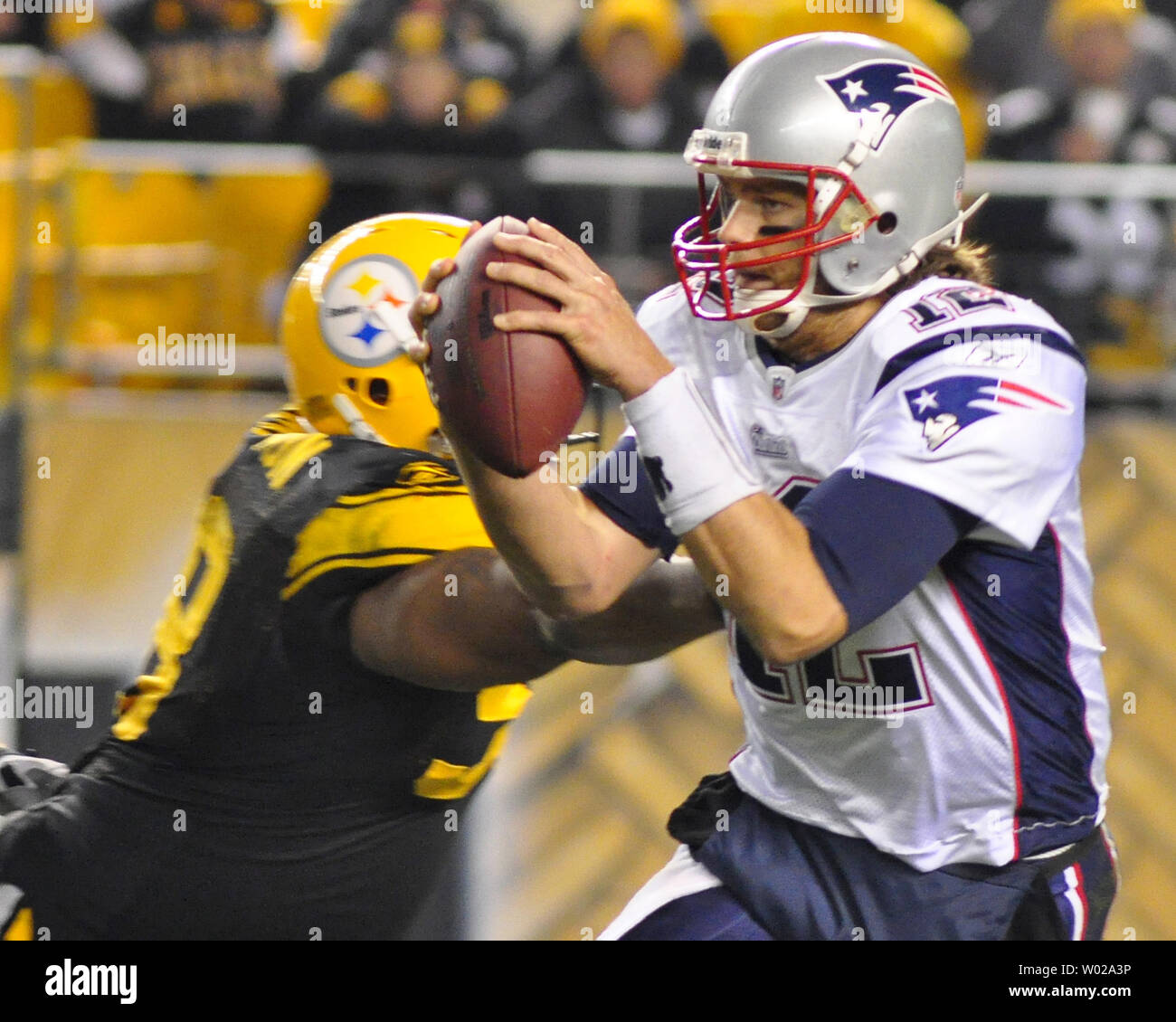 New England Patriots quarterback Tom Brady evades Pittsburgh Steelers  defensive tackle Casey Hampton and completes a pass in the third quarter of  the Patriots 39-26 victory over the Steelers at Heinz Field