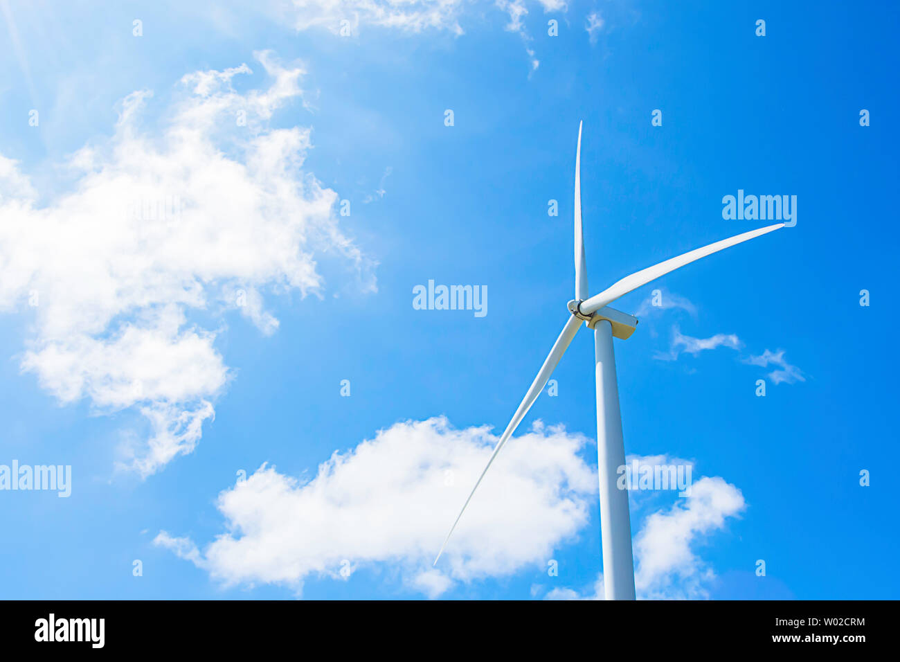 Wind turbines generate electricity and the bright blue sky at Khao Kho of phetchabun in Thailand. Stock Photo