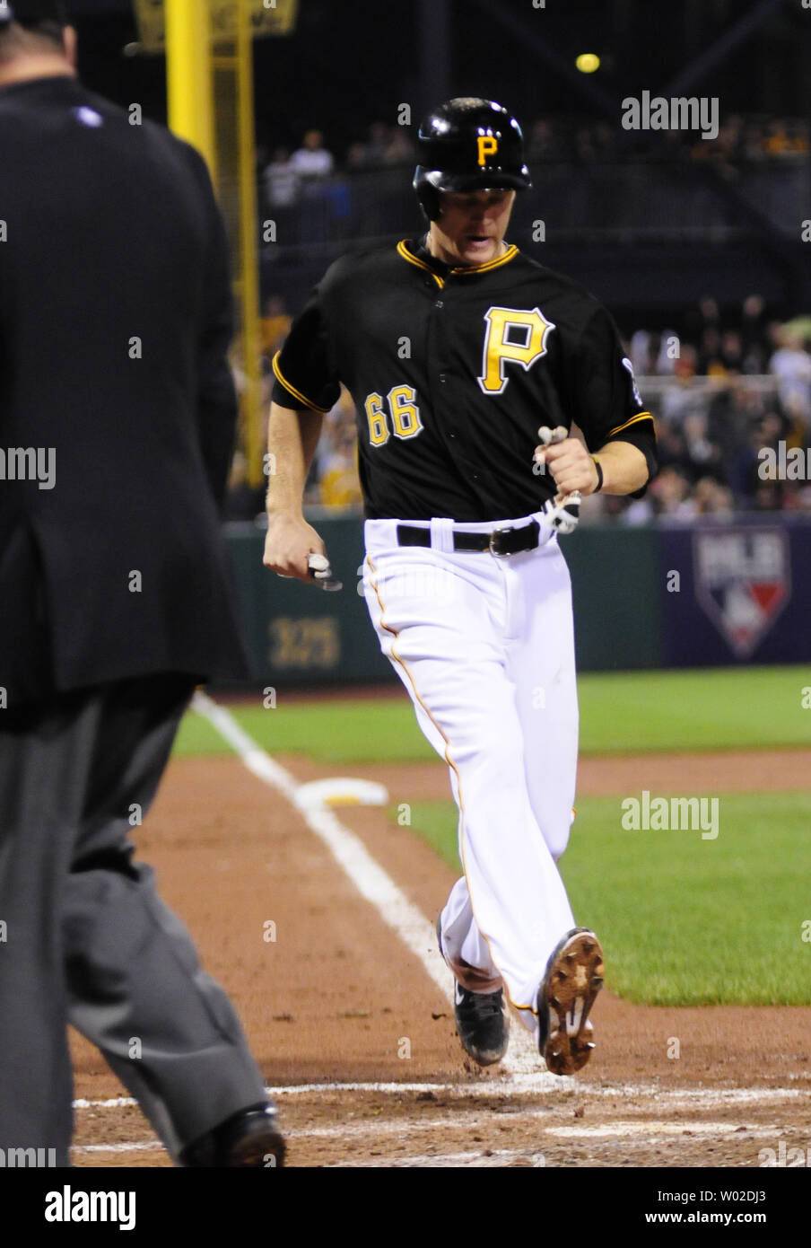 Pittsburgh Pirates first baseman Justin Morneau (66) cores on a Pirates  Pedro Alvarez (24) single to left field in the sixth inning of the 4-2 win  over the Cincinnati Reds at PNC