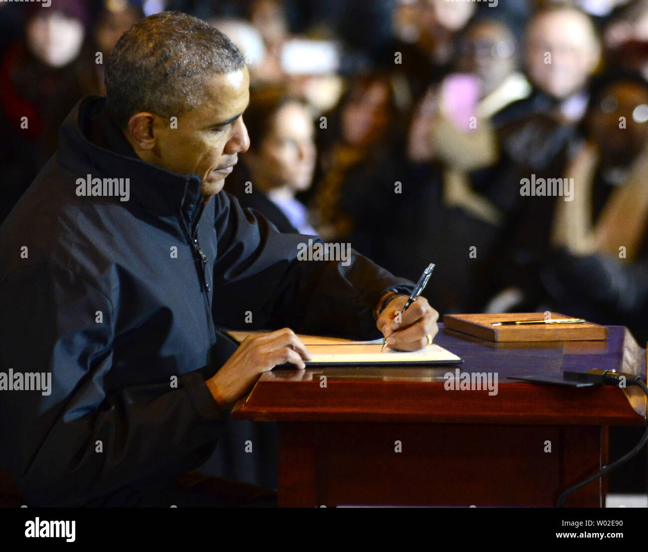 President Barack Obama signs a presidential mandate after addressing workers and guests at the U. S. Steel Irvin Plant in West Mifflin, Pennsylvania on January 29, 2014.   UPI/Archie Carpenter Stock Photo
