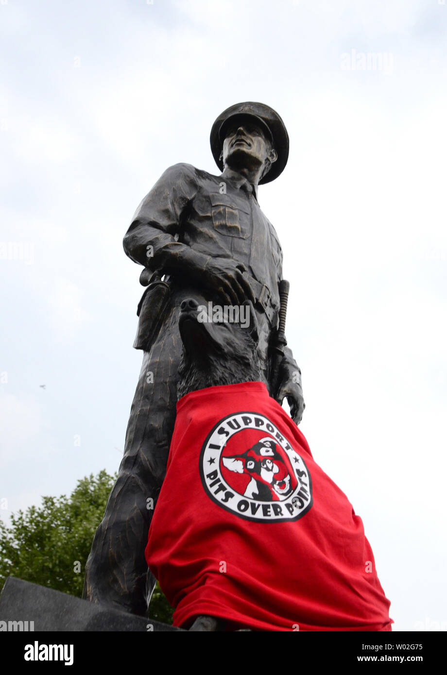 A tee shirt placed by a demonstrator adorns a statue of a canine officer, protesting the Pittsburgh Steelers signing of Mike Vick before the start of the Steelers  preseason game against the Carolina Panthers near the entrance of Heinz Field in Pittsburgh on September 3, 2015.  Photo by Archie Carpenter/UPI Stock Photo