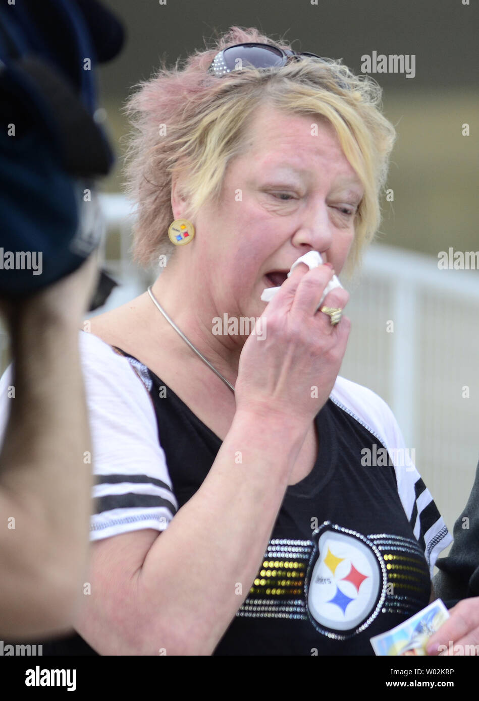 A Pittsburgh Steelers fans shows her grief after paying her final respects to Dan Rooney, Chairman of the Pittsburgh Steelers at the public viewing services at  Heinz Field in Pittsburgh on April 17, 2017.  Photo by Archie Carpenter/UPI Stock Photo