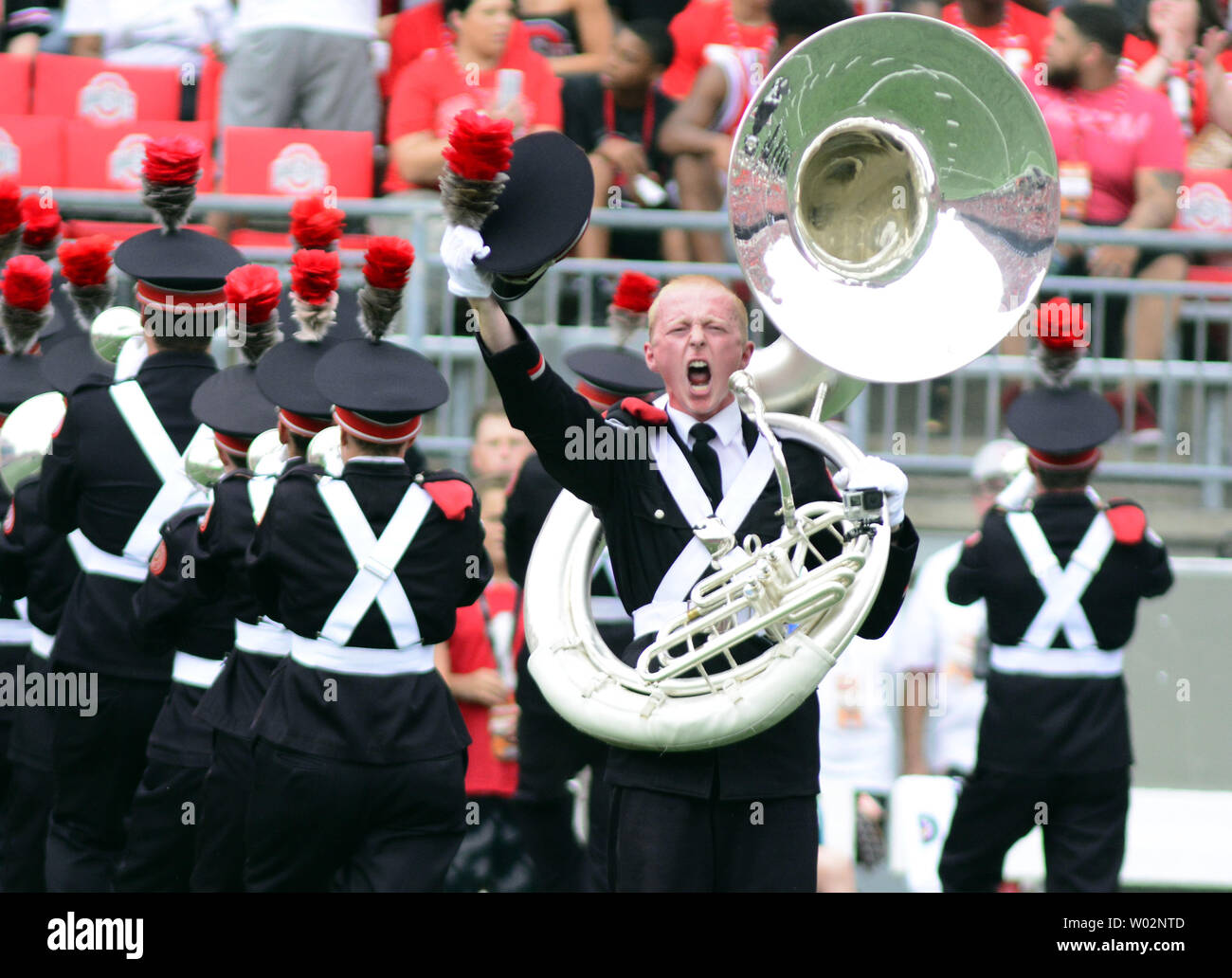 The Ohio State University Marching Band sousaphone player dots the "I