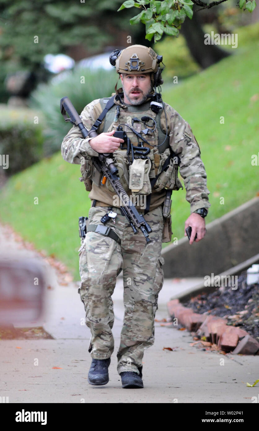 Pittsburgh police officer departs the scene of the mass shooting at the Tree of Life Synagogue in the Squirrel Hill neighborhood of Pittsburgh where at least 11 people have died on October 27, 2018 .  The shooter, Robert Bowers, armed with an assault rifle killed 11 people before surrendering to the police .  Photo by Archie Carpenter/UPI Stock Photo