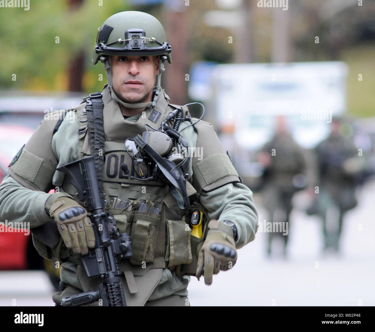 Pittsburgh police officer departs the scene of the mass shooting at the Tree of Life Synagogue in the Squirrel Hill neighborhood of Pittsburgh where at least 11 people have died on October 27, 2018 .  The shooter, Robert Bowers, armed with an assault rifle killed 11 people before surrendering to the police .  Photo by Archie Carpenter/UPI Stock Photo
