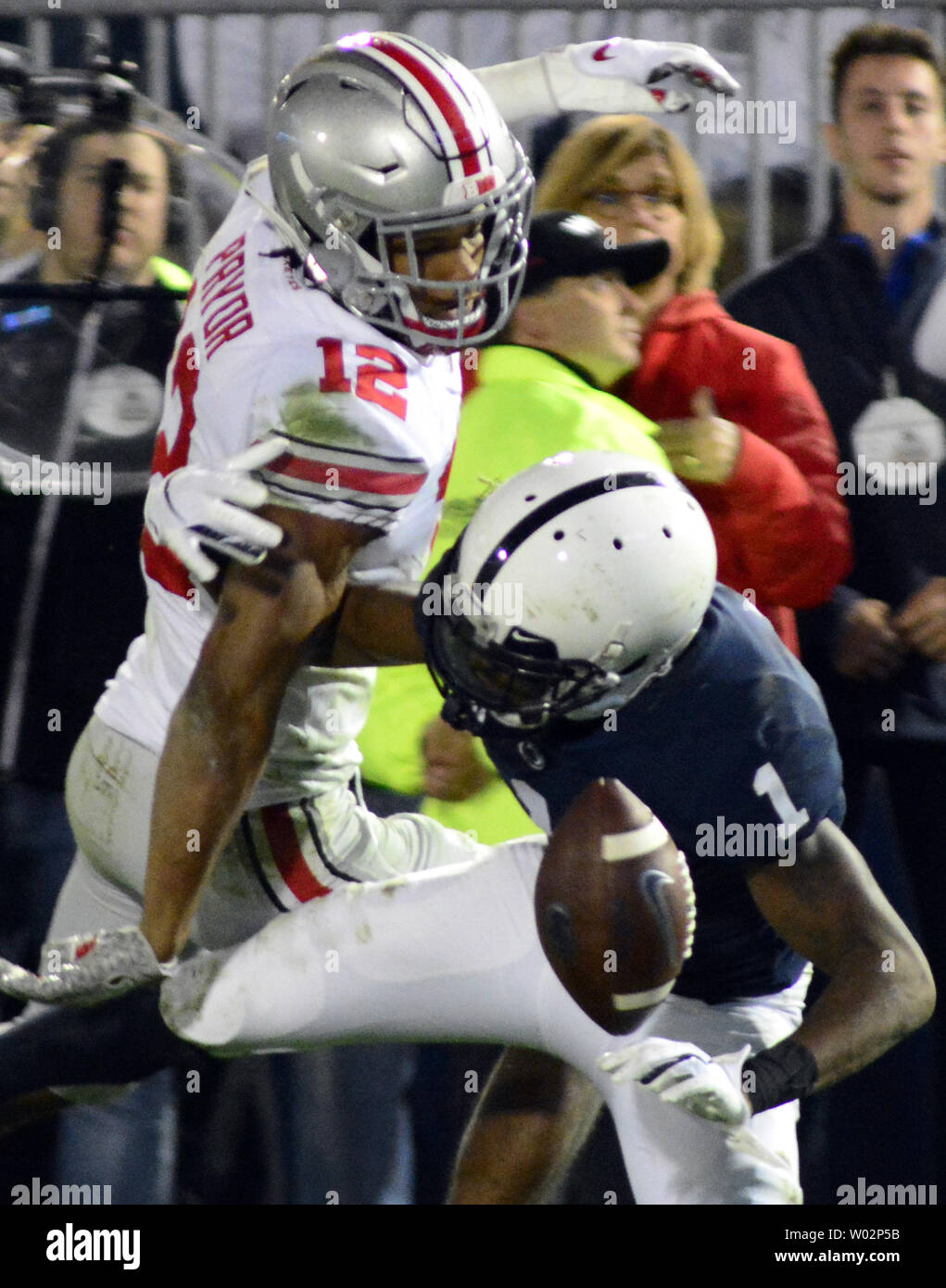 Ohio State Buckeyes safety Isaiah Pryor (12)  receives a defensive interference call as Penn State Nittany Lions wide receiver KJ Hamler (1) falls to the turf in the third quarter of the Ohio State Buckeyes 27-26 victory at Beaver Stadium in State College , Pennsylvania on September 29, 2018. Photo by Archie Carpenter/UPI Stock Photo