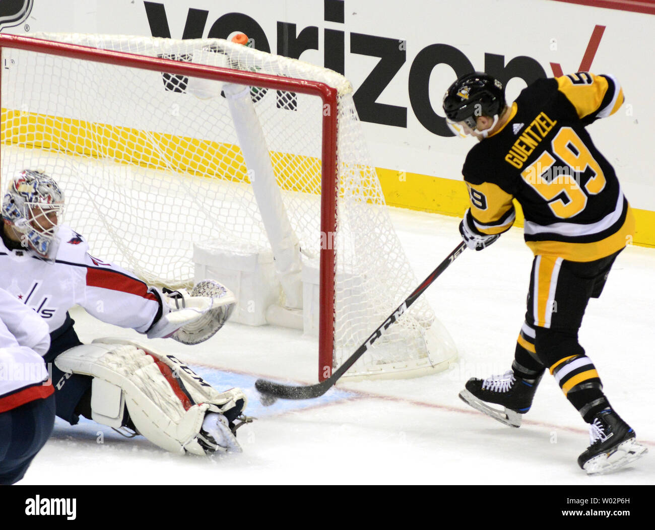 Pittsburgh Penguins center Jake Guentzel (59) shots and scores against the Washington Capitals goaltender Braden Holtby (70) the first period against the Washington Capitals at the Penguins home opener at PPG Paints Arena in Pittsburgh on October 4, 2018.   Photo by Archie Carpenter/UPI Stock Photo