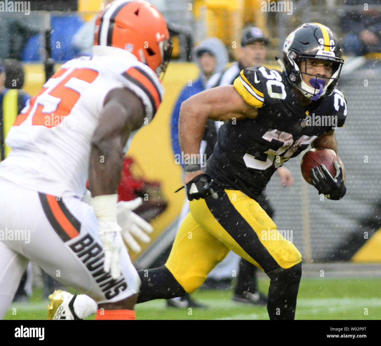 Pittsburgh Steelers running back James Conner (30) glances at Cleveland Browns linebacker Genard Avery (55) and runs 22 yards for a touchdown in the fourth quarter of the Steelers 33-18 win at Heinz Field on October 28, 2018 .  Photo by Archie Carpenter/UPI Stock Photo