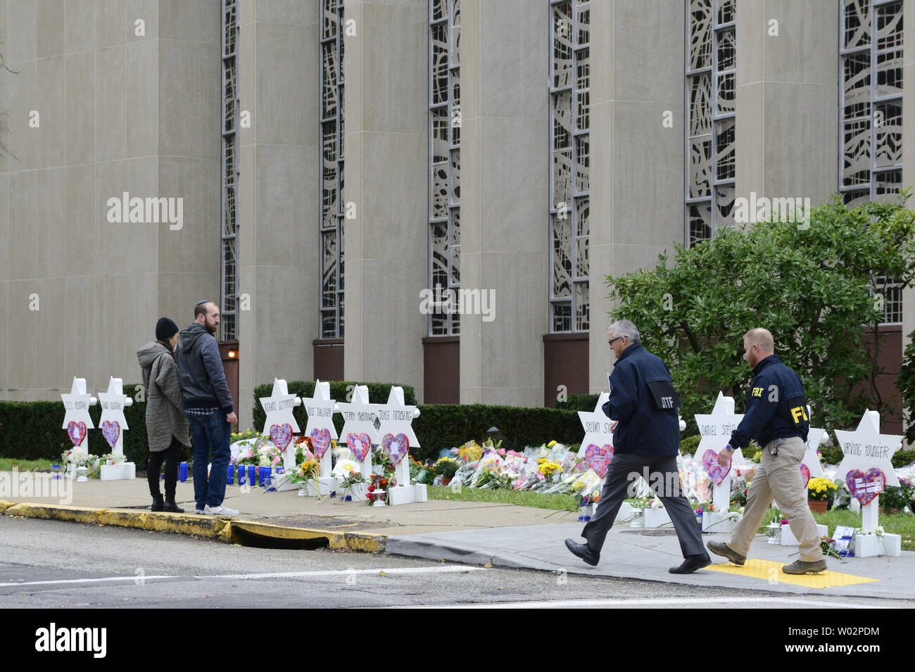A couple pauses at the temporary memorial as JTTF and FBI investigators  walk by the Tree of Life Synagogue where 11  people were shoot over the weekend in the Squirrel Hill neighborhood of Pittsburgh on October 29, 2018.  Photo by Archie Carpenter/UPI Stock Photo