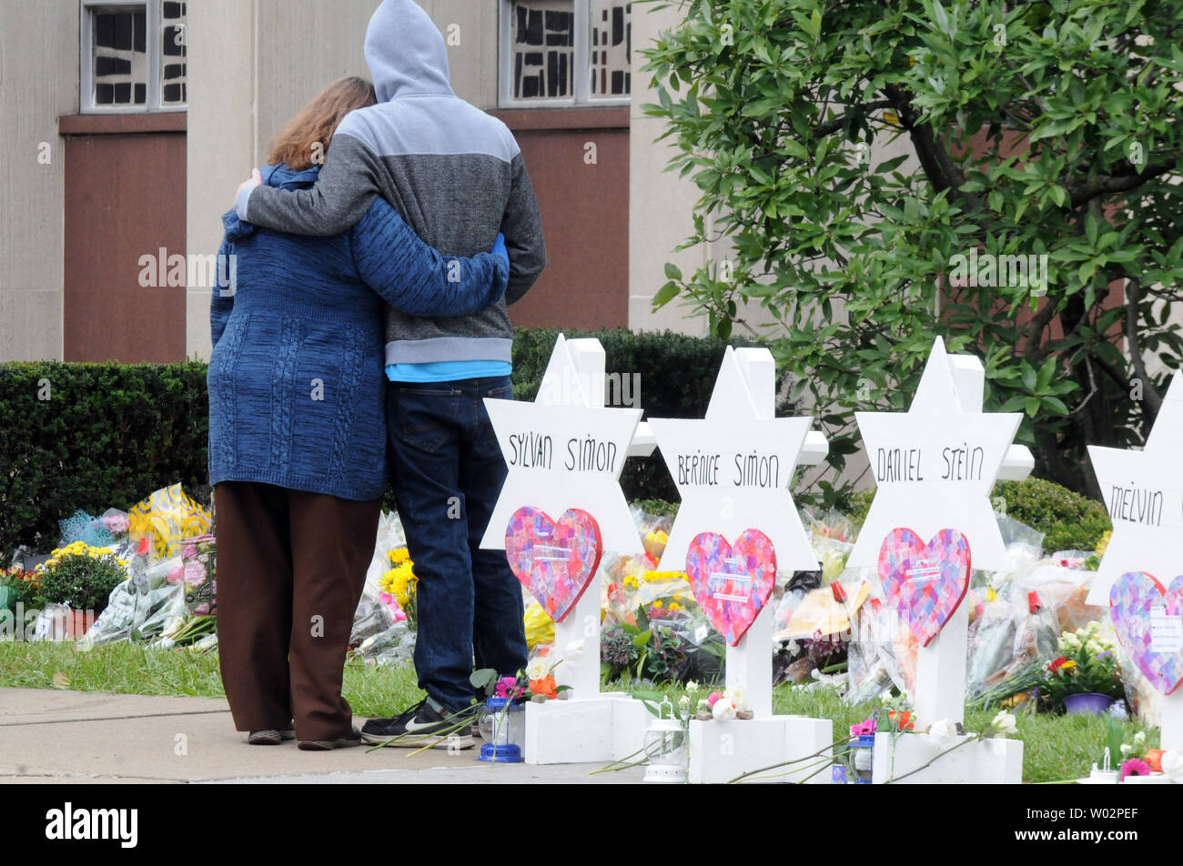 A couple embrace after placing flowers at the temporary memorial at the Tree of Life Synagogue where 11 people were killed over the weekend in the Squirrel Hill neighborhood of Pittsburgh on October 29, 2018.  Photo by Archie Carpenter/UPI Stock Photo