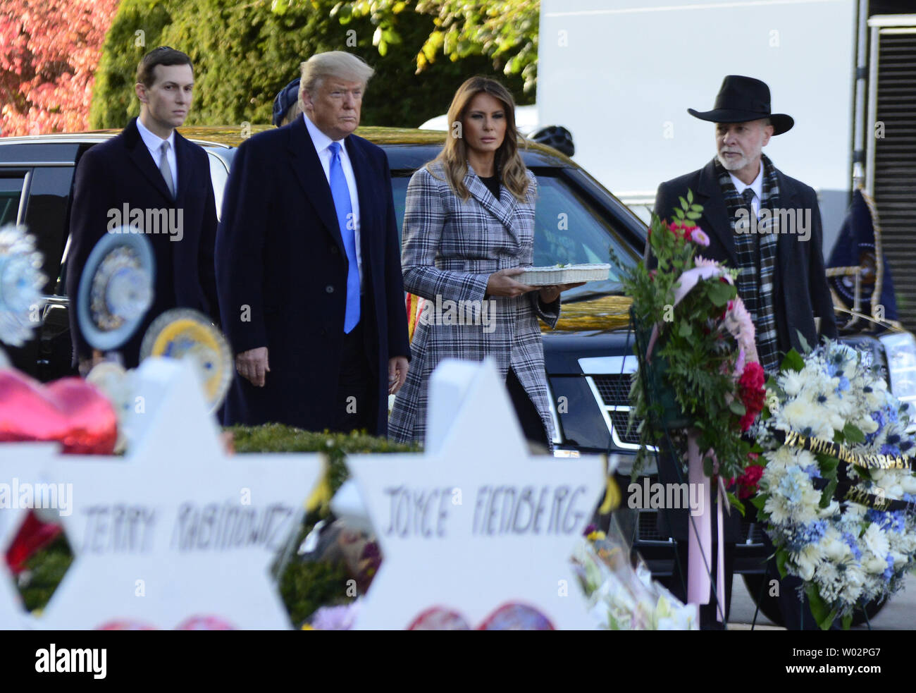 Rabbi Jeffery Meyers escorts President Donald Trump with First Lady Melania Trump as they place stones and flowers at each of the Stars of David  erected for the 11 victims of the mass shooting on Saturday morning at the Tree of Life Synagogue in the Squirrel Hill neighborhood of Pittsburgh on October 30, 2018.  Photo by Archie Carpenter/UPI Stock Photo