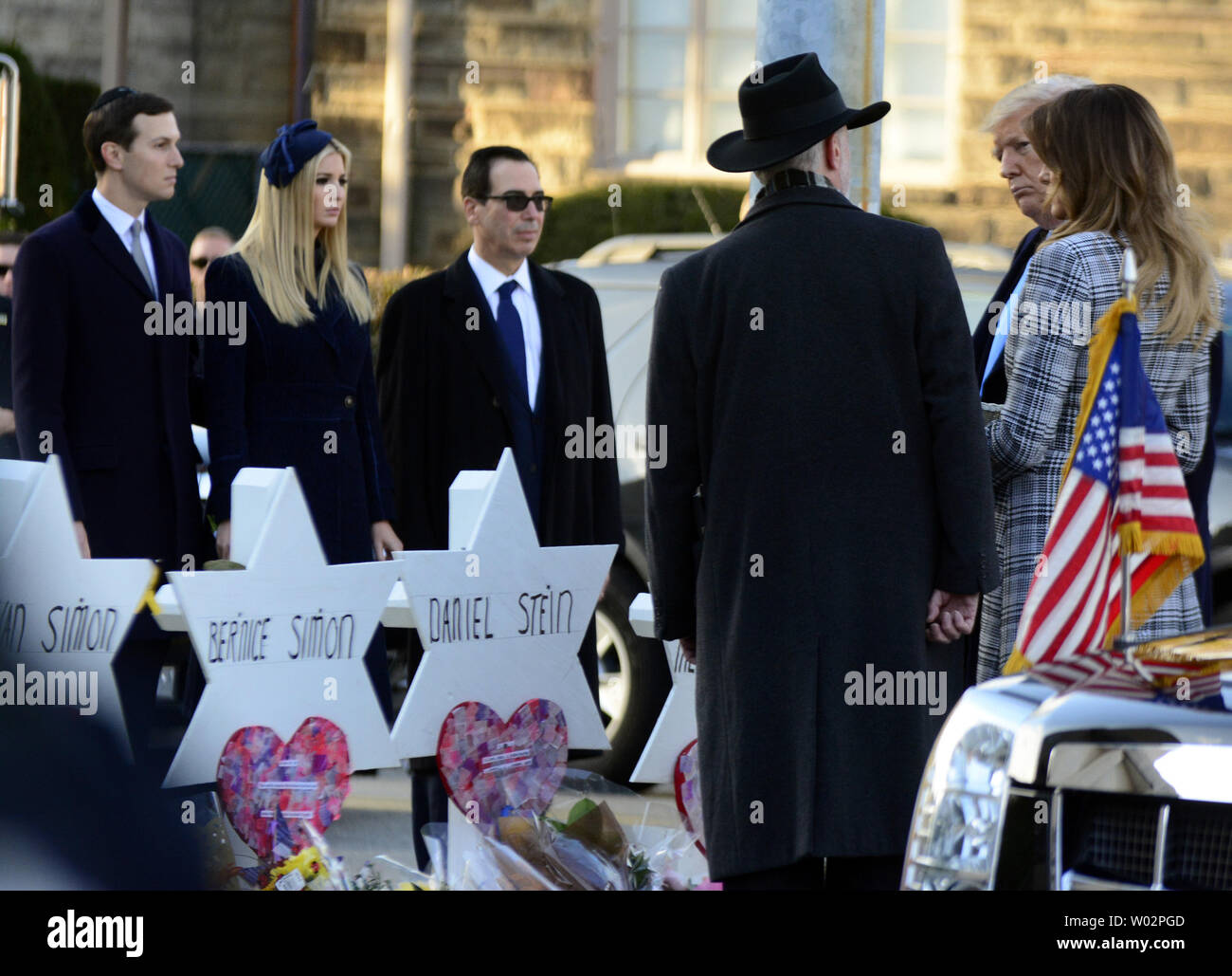 Rabbi Jeffrey Myers escorts President Donald Trump with First Lady Melania Trump as they place stones and flowers at each of the Stars of David  erected for the 11 victims of the mass shooting on Saturday morning at the Tree of Life Synagogue in the Squirrel Hill neighborhood of Pittsburgh on October 30, 2018.  Photo by Archie Carpenter/UPI Stock Photo
