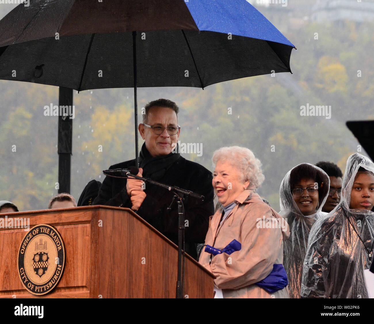 Mrs.  Joanne Rogers, widow of Mr. Rogers shares a laugh after Tom Hanks is corrected by the crowd on the pronunciation of Taylor Allerdice High School at the Rally for Peace in Point State Park in Pittsburgh on November 9, 2018. The rally was held to remember the 11 people that lost their lives at the Tree of Life Synagogue shooting.   Photo by Archie Carpenter/UPI Stock Photo