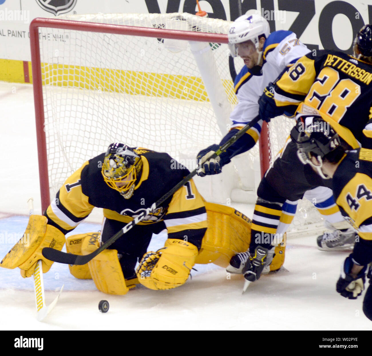 Pittsburgh Penguins goaltender Casey DeSmith (1) covers the puck protecting it from St. Louis Blues left wing David Perron (57) during the second period of the Blues 5-1 win at PPG Paints Arena in Pittsburgh on March 16, 2018.   Photo by Archie Carpenter/UPI Stock Photo