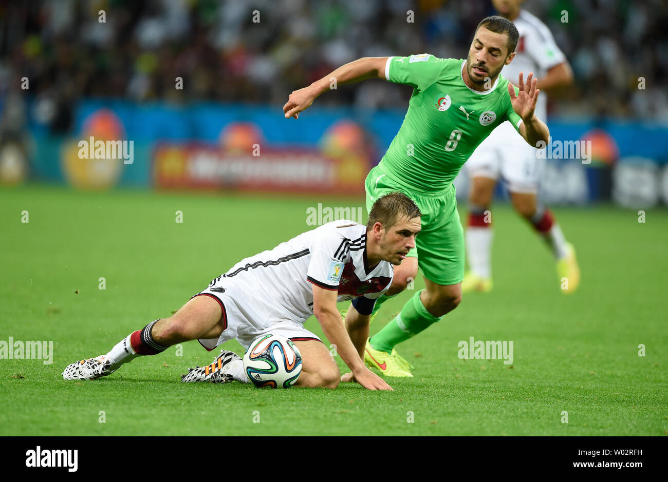 Philipp Lahm (L) of Germany competes with Djamel Mesbah of Algeria during the 2014 FIFA World Cup Round of 16 match at the Estadio Beira-Rio in Porto Alegre, Brazil on June 30, 2014. UPI/Chris Brunskill Stock Photo