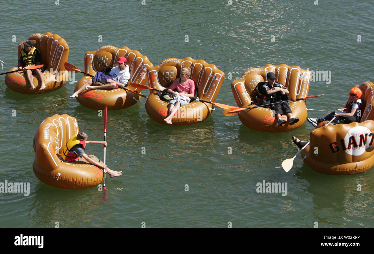 Baesball fans camp out on floating baseball gloves in McCovey Cove on