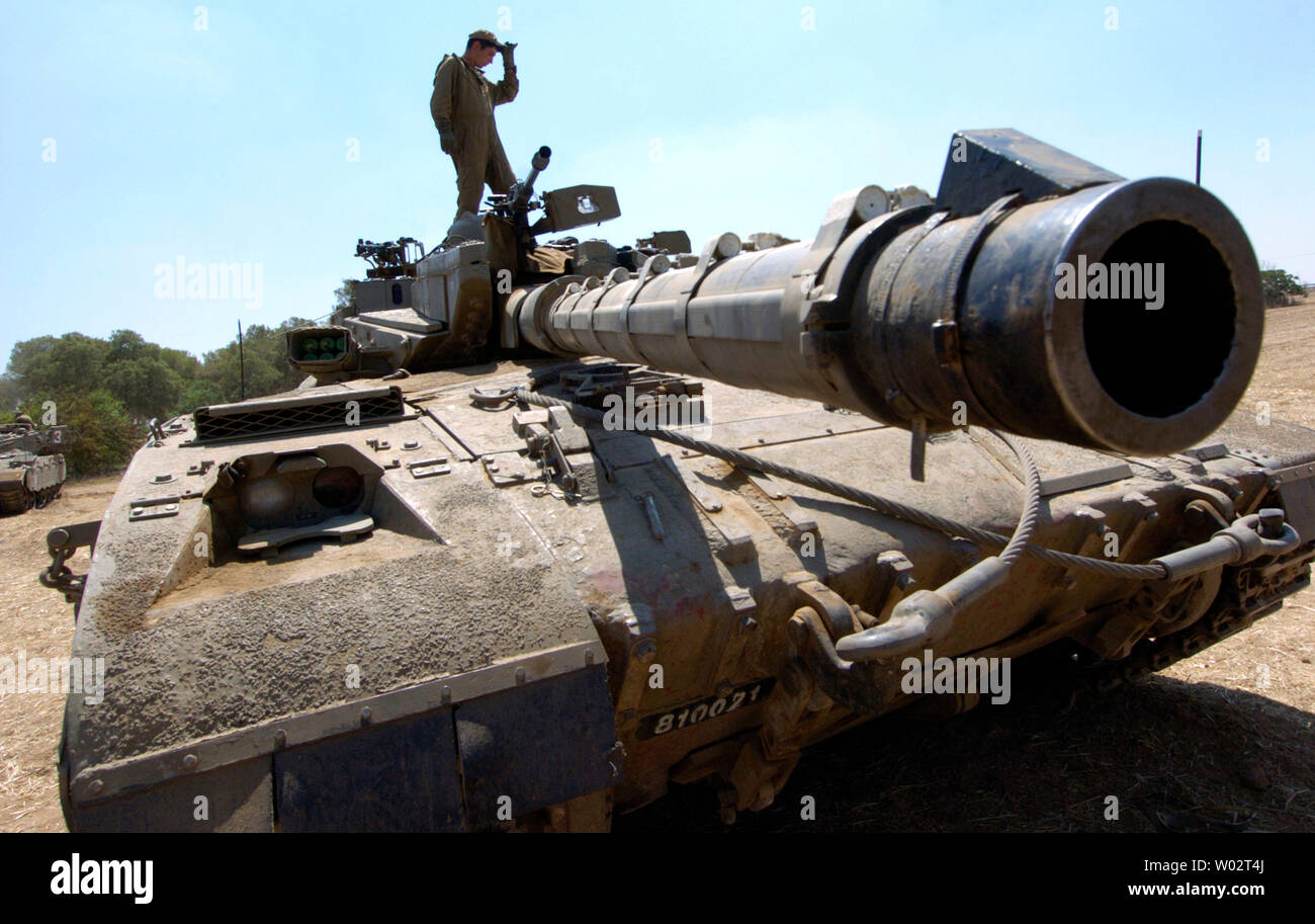 Israeli soldiers work on tanks in a temporary camp near Kibbutz Mefalsim outside northern Gaza, June 27, 2006. Israeli officials have threatened a military strike against Hamas leaders and Palestinian militants if an abducted Israeli soldier is not released.  (UPI Photo/Debbie Hill) Stock Photo