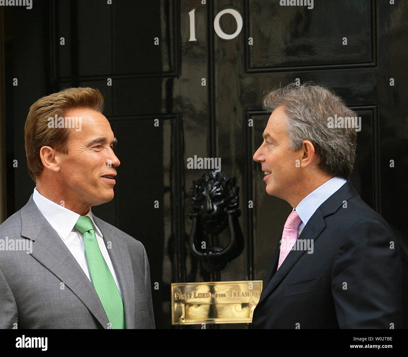 British Prime Minister Tony Blair (R) greets the Governor of California  Arnold Schwarzenegger (L) on the doorstep of No.10 Downing Street, where  they are discussing climate concerns, on June 26, 2007. It