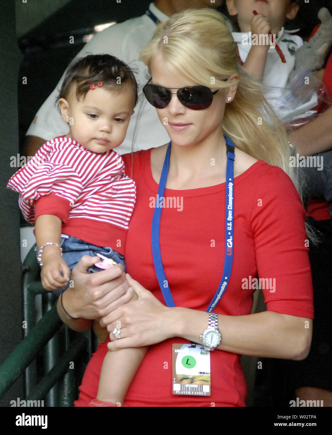 Tiger Woods's wife Elin Nordegren carries their daughter Sam as they watch Woods putt on the 18th green during the final round of the US Open at Torrey Pines Golf Course in San Diego on June 15, 2008. Woods finished his round tied for first with Rocco Mediate. A playoff round between Woods and Mediate will be held tomorrow. (UPI Photo/Earl Cryer) Stock Photo