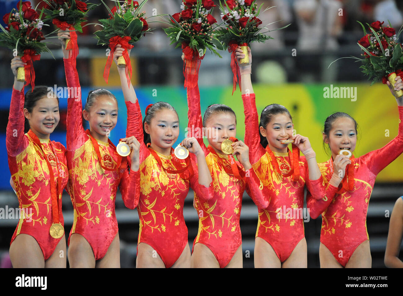 The Chinese Womens Gymnastics Team Shows Their Gold Medals On The Awards Podium For The Womens 