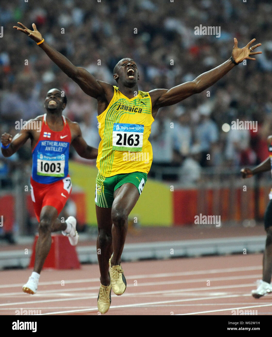 Jamaica's Usain Bolt jubilates as he crosses the finish line and sees that he has won the gold medal and broken the world record in the Men's 200 meter race at the National Stadium at the Summer Olympics in Beijing on August 20, 2008. Bolt set a new world record of 19.30. seconds, breaking USA's Michael Johnson's record of 19.32 set in 1996.  At left is silver medalist Churandy Martina (1003) of the Netherlands Antilles.    (UPI Photo/Pat Benic) Stock Photo