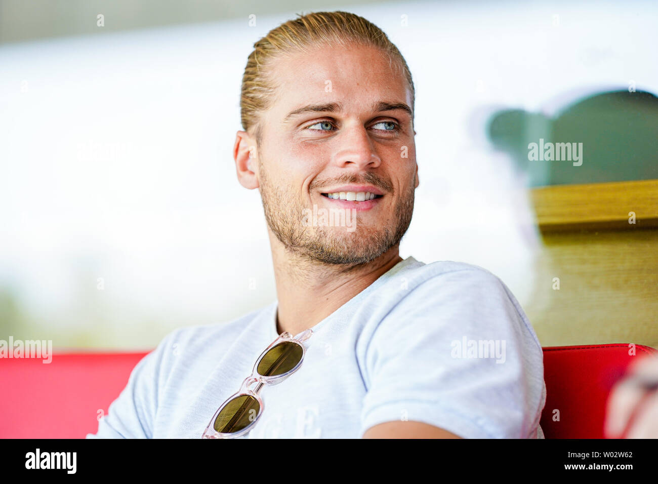 Sandhausen, Germany. 25th June, 2019. Rurik Gislason, player of the second division football team SV Sandhausen, is sitting on the stadium grandstand during a conversation. Gislason from SV Sandhausen became world famous a year ago. Not because he delivered sensational performances for Iceland at the World Cup in Russia, but because of his appearance. (to dpa 'One year after the hype: The new life of the 'beautiful' Rurik Gislason') Credit: Uwe Anspach/dpa/Alamy Live News Stock Photo