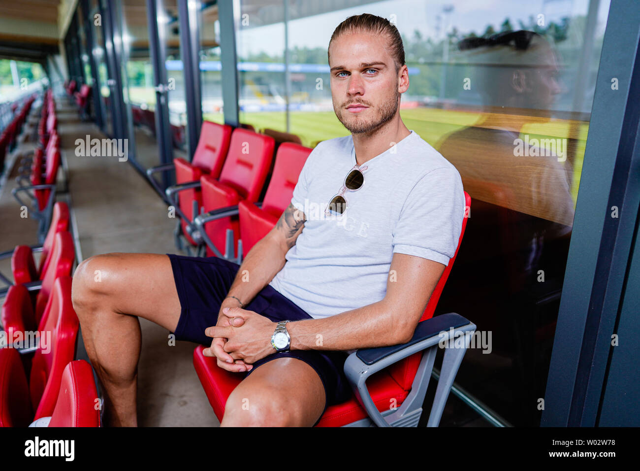 Sandhausen, Germany. 25th June, 2019. Rurik Gislason, player of the second division football team SV Sandhausen, sits on the stadium grandstand. Gislason from SV Sandhausen became world famous a year ago. Not because he delivered sensational performances for Iceland at the World Cup in Russia, but because of his appearance. (to dpa 'One year after the hype: The new life of the 'beautiful' Rurik Gislason') Credit: Uwe Anspach/dpa/Alamy Live News Stock Photo