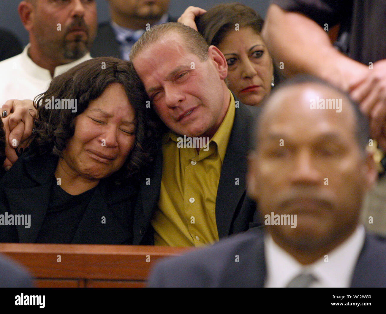 O.J. Simpson's sister Carmelita Durio (L) and friend Tom Scotto react as Simpson is found guilty on all 12 charges, including felony kidnapping, armed robbery and conspiracy at the Clark County Regional Justice Center in Las Vegas, Nevada on October 3, 2008. The verdict comes 13 years to the day after Simpson was acquitted of murdering his ex-wife Nicole Brown Simpson and Ron Goldman. (UPI Photo/Daniel Gluskoter) Stock Photo