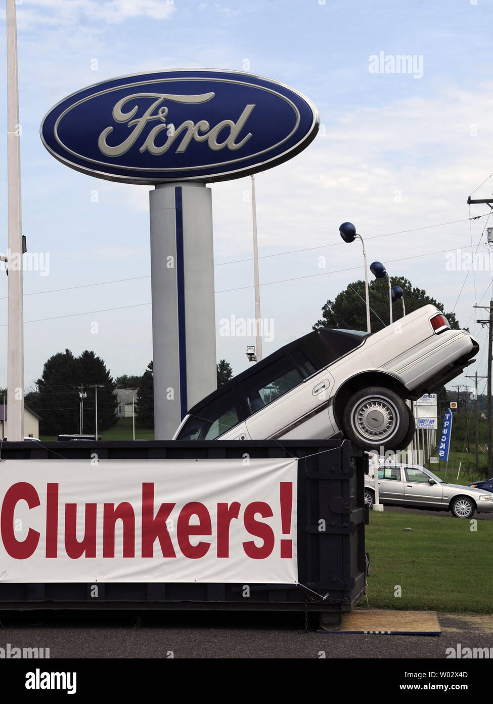 A Display With A Car In A Dumpster At A Ford Auto Dealership Advertises 
