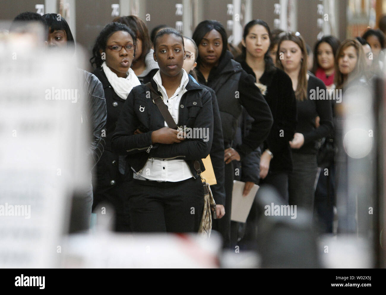 Applicants line up for a job fair at a newly opening Forever 21 store