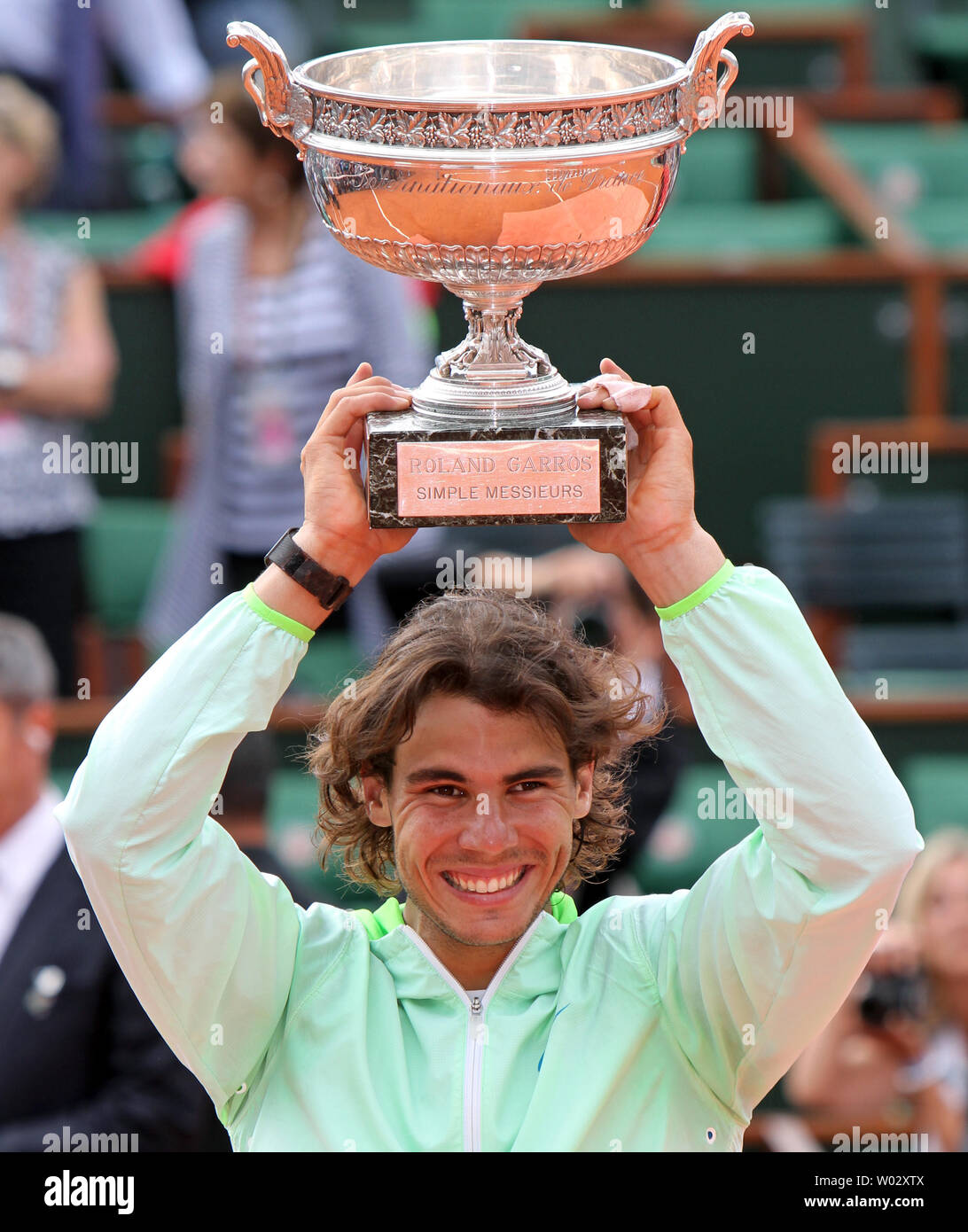 Spaniard Rafael Nadal holds the championship trophy after winning his  French Open men's final match against Swede Robin Soderling at Roland  Garros in Paris on June 6, 2010. Nadal defeated Soderling 6-4,