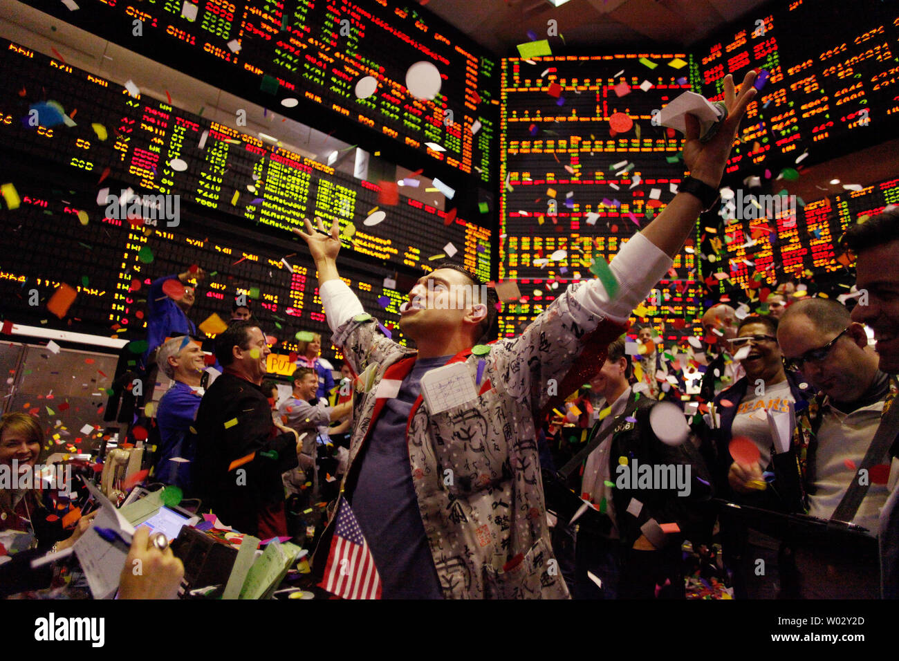 Jason Kelly, a trader in the Wheat Options pit at the CME Group throws up his arms as traders toss confetti at the closing bell for the year on December 31, 2009 in Chicago.     UPI/Brian Kersey Stock Photo