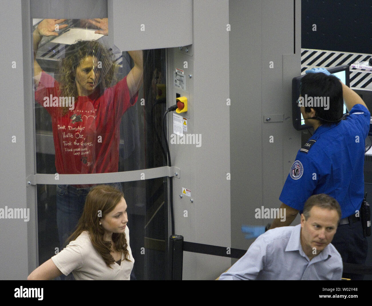 A Transportation Security Administration (TSA) agent processes passengers through the full body scanner at Denver International Airport less than a week away from the Thanksgiving holiday on November 19, 2010 in Denver.     UPI/Gary C. Caskey Stock Photo