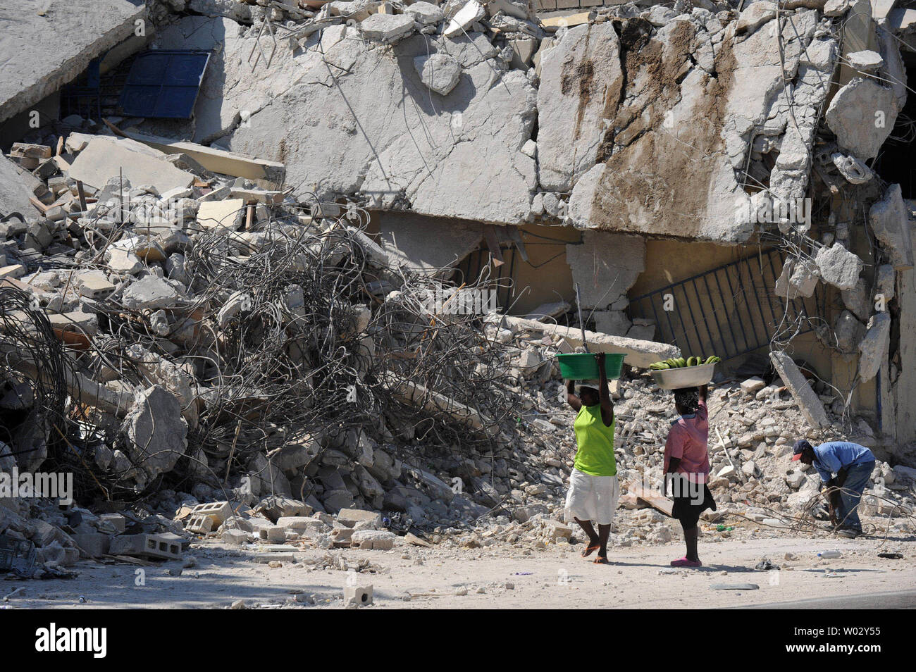 Women Stop To Look At Rubble On An Earthquake Damaged Street In Port Au Prince Haiti