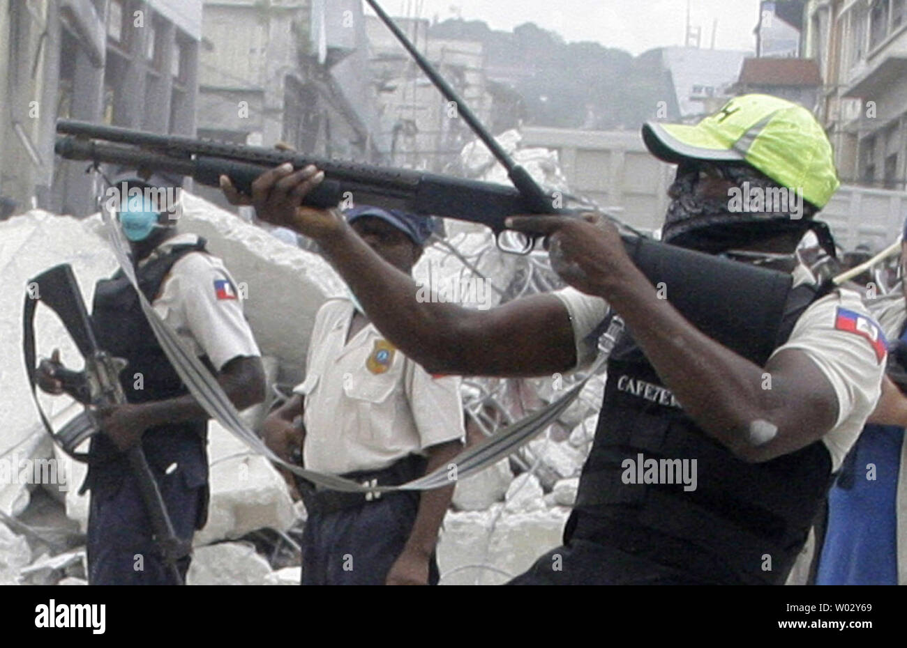 Haitian police shoot rubber bullets to stop looters in Port-au-Prince, Haiti on January 19, 2010, after a 7.0 magnitude earthquake caused severe damage on January 12. UPI/Anatoli Zhdanov Stock Photo