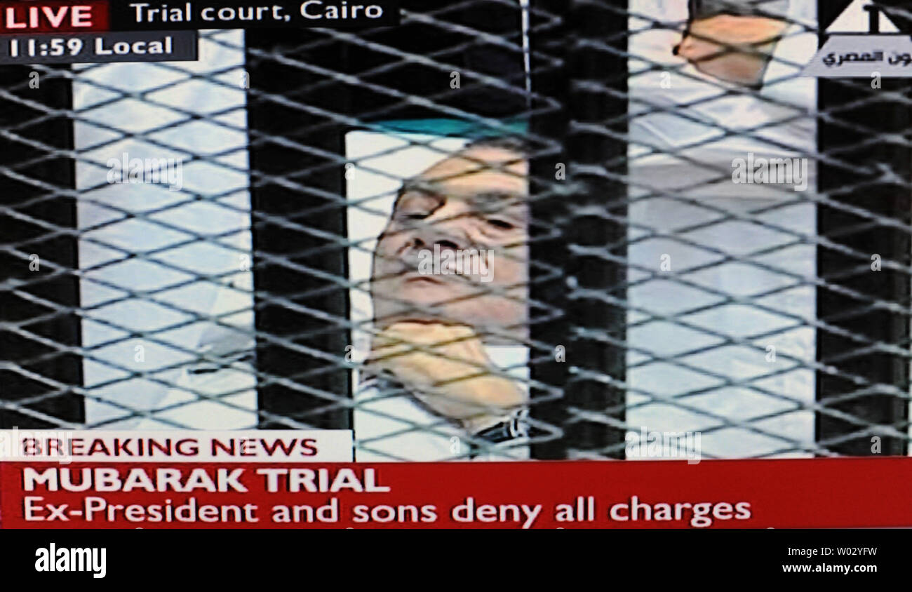 Video image taken from Egyptian State Television shows former Egyptian President Hosni Mubarak, 83, wearing white prison clothes,in a hospital bed inside a cage in a Cairo courtroom, August 3, 2011. Mubarak and his two sons, Alaa and Gamal, are being tried on charges of corruption and ordering the killing of protesters during the revolution that ended his reign after 18 days of popular protest. UPI/Debbie Hill Stock Photo