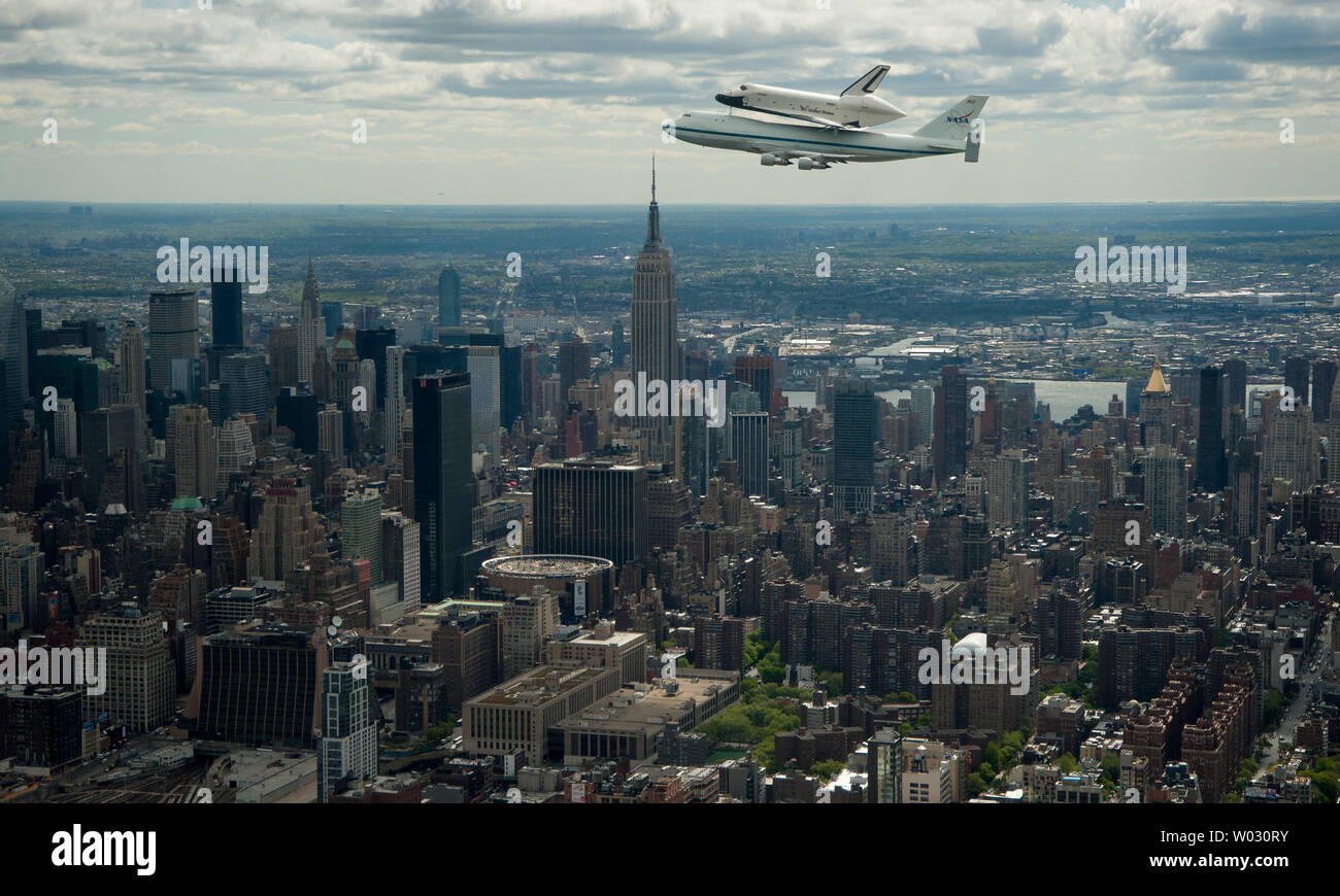Space shuttle Enterprise, mounted atop a NASA 747 Shuttle Carrier Aircraft (SCA), is seen as it flies near the Empire State Building, April 27, 2012, in New York. Enterprise was the first shuttle orbiter built for NASA performing test flights in the atmosphere and was incapable of spaceflight. Originally housed at the Smithsonian's Steven F. Udvar-Hazy Center, Enterprise will be demated from the SCA and placed on a barge that will eventually be moved by tugboat up the Hudson River to the Intrepid Sea, Air & Space Museum in June.   UPI/NASA/Robert Markowitz Stock Photo