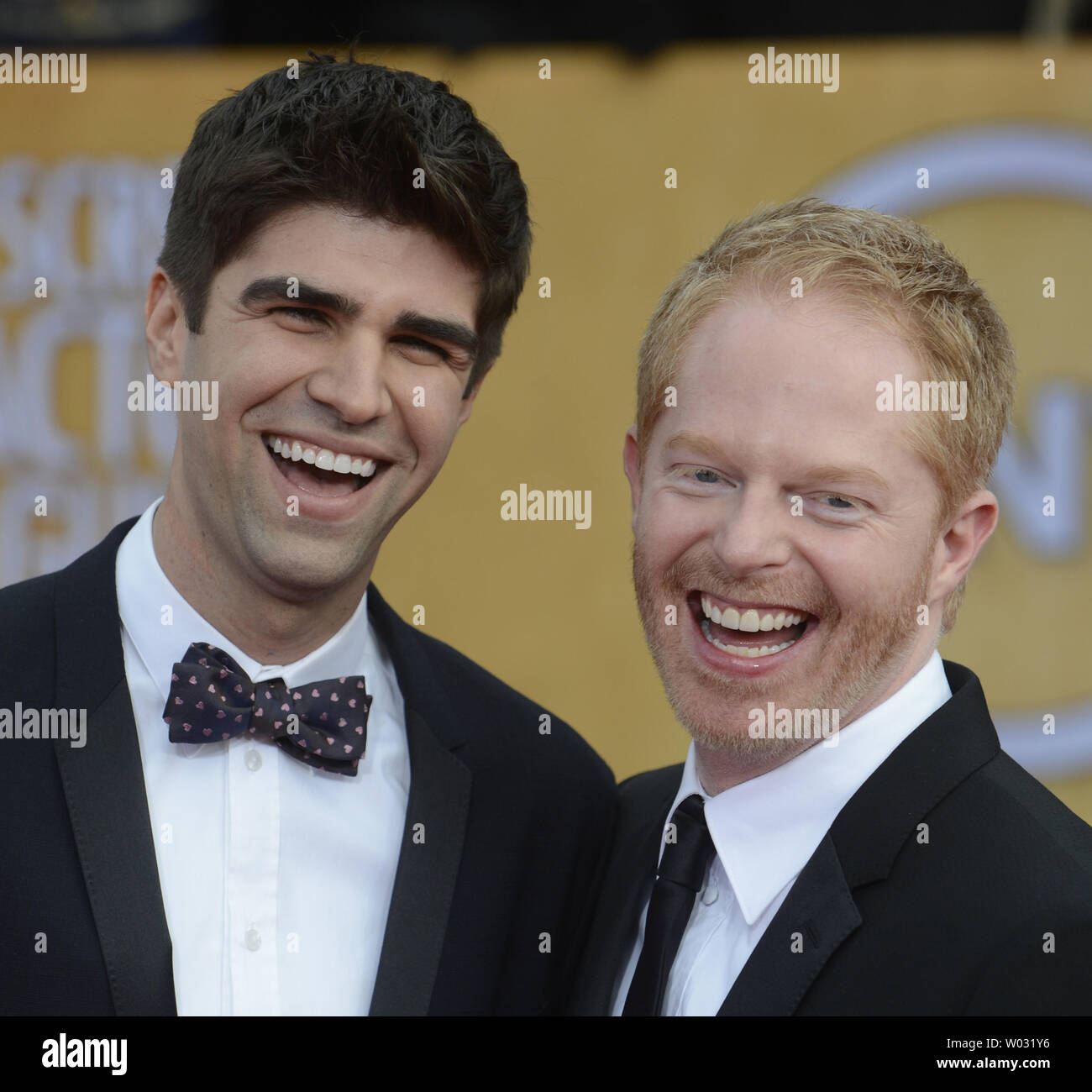 Actor Jesse Tyler Ferguson (R) and Justin Mikita arrive for the 19th Annual SAG Awards held at the Shrine Auditorium in Los Angeles on on January 27, 2013.   UPI/Phil McCarten Stock Photo