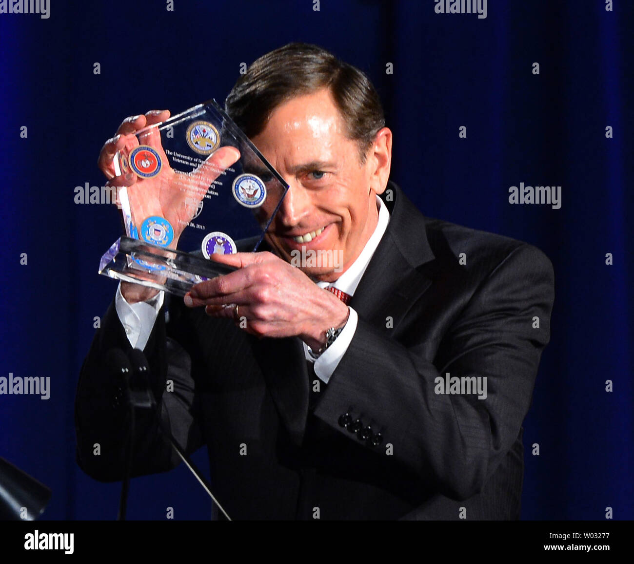 Former CIA director David Petraeus displays a token of appreciation presented to him following Petraeus' address at a University of Southern California event honoring the military  in Los Angeles, California on March 26, 2013. In the first public appearance since stepping down last November as head of the CIA after admitting to an affair, Petraeus said he regretted and apologized for the circumstances that led to his resignation.   UPI/Jim Ruymen Stock Photo