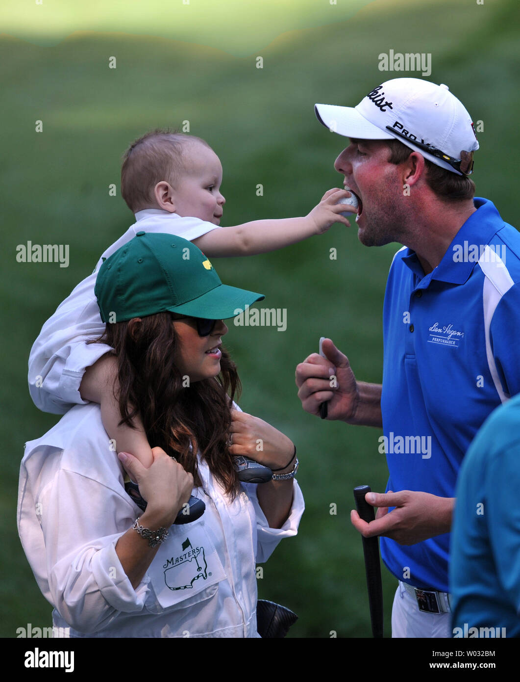 Marc Leishman's son Harvey puts a golf ball into his father's mouth during the Masters Par 3 Contest, a day before the beginning of the Masters tournament, at Augusta National,  in Augusta, Georgia on April 10, 2013. UPI/Kevin Dietsch Stock Photo