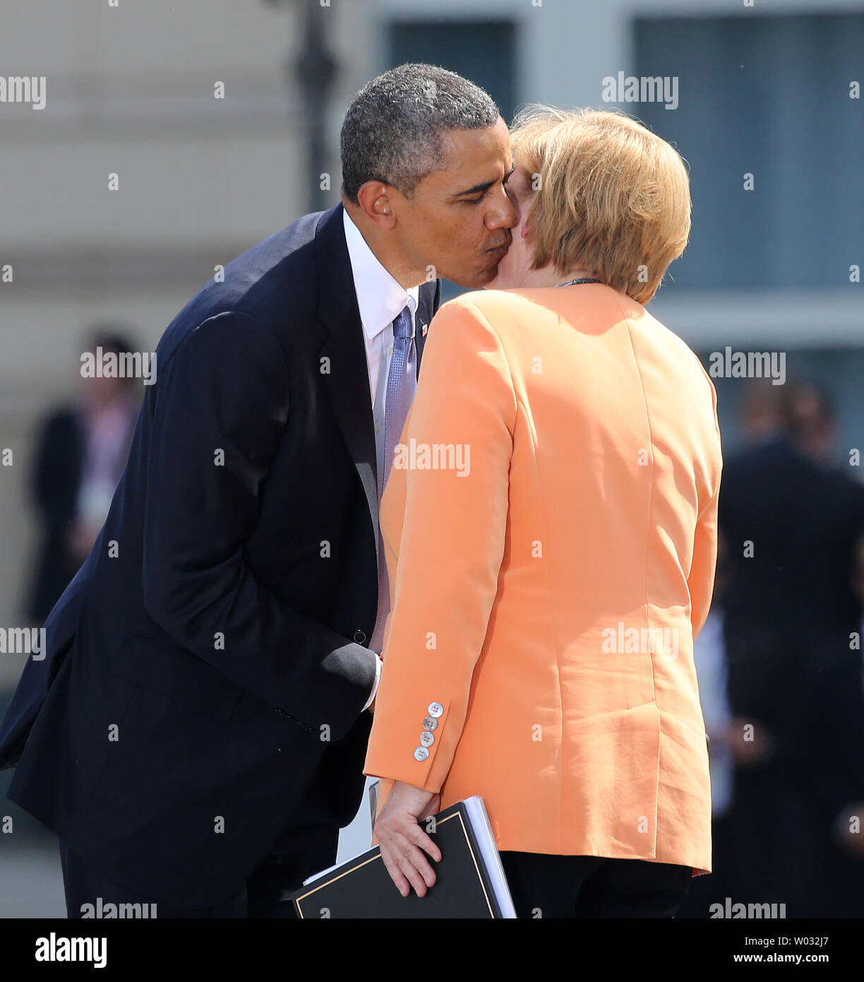 U.S. President Barack Obama kisses German Chancellor Angela Merkel after  she finished her speech at the Brandenburg Gate in Berlin on June 19, 2013.  Obama is in Berlin on his first official