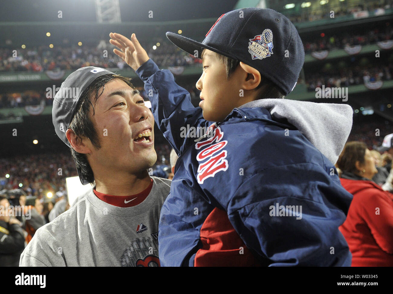 Boston Red Sox closer Koji Uehara holds his son Kazuma as they celebrate on  the field after the Red Sox won the 2013 World Series defeating the St.  Louis Cardinals in game