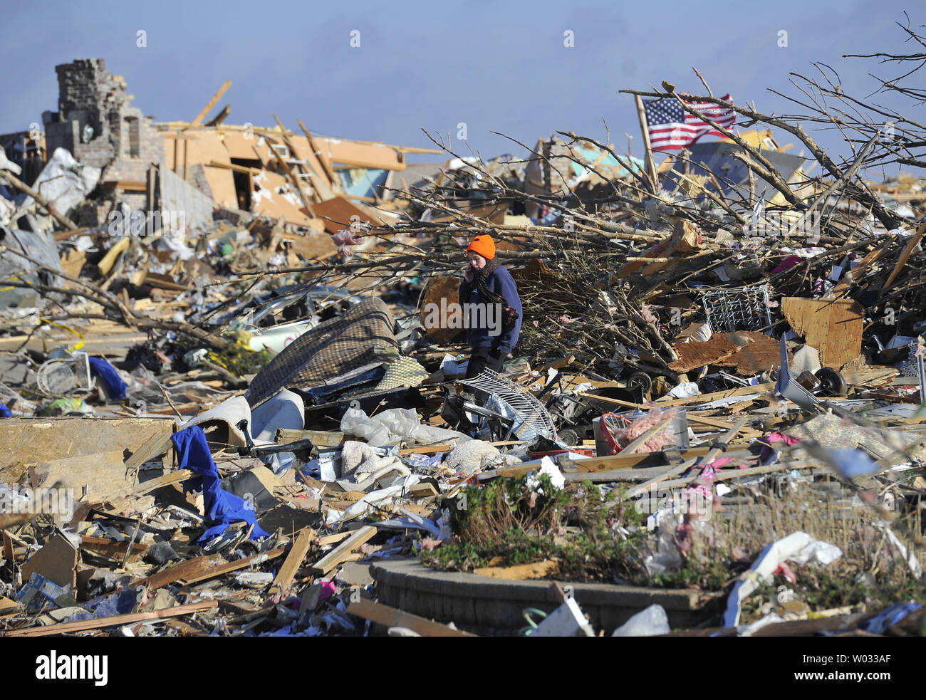 Nicole Janardhan looks for her belongings among the debris of her neighborhood in Washington, Illinois on November 18, 2013. Six people died and hundreds of homes were destroyed in Illinois as 81 tornadoes were sighted on November 17 throughout 12 midwest states including the EF4 tornado that struck Washington, Illinois.     UPI/Brian Kersey.     UPI/Brian Kersey Stock Photo