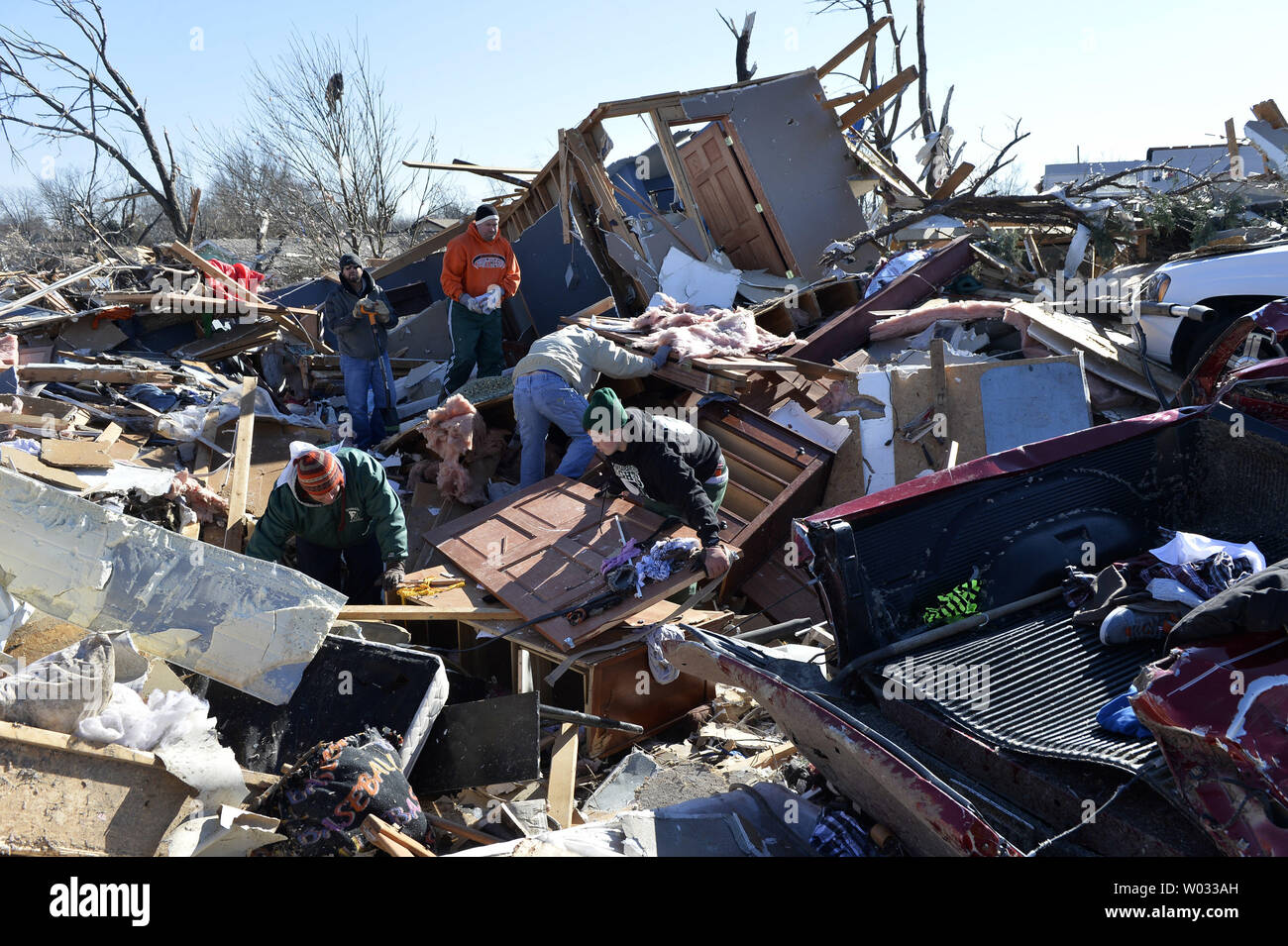 Residents sort through the devastation following a tornado in Washington, Illinois on November 18, 2013. Six people died and hundreds of homes were destroyed in Illinois as 81 tornadoes were sighted on November 17 throughout 12 midwest states including the EF4 tornado that struck Washington, Illinois.     UPI/Brian Kersey.     UPI/Brian Kersey Stock Photo
