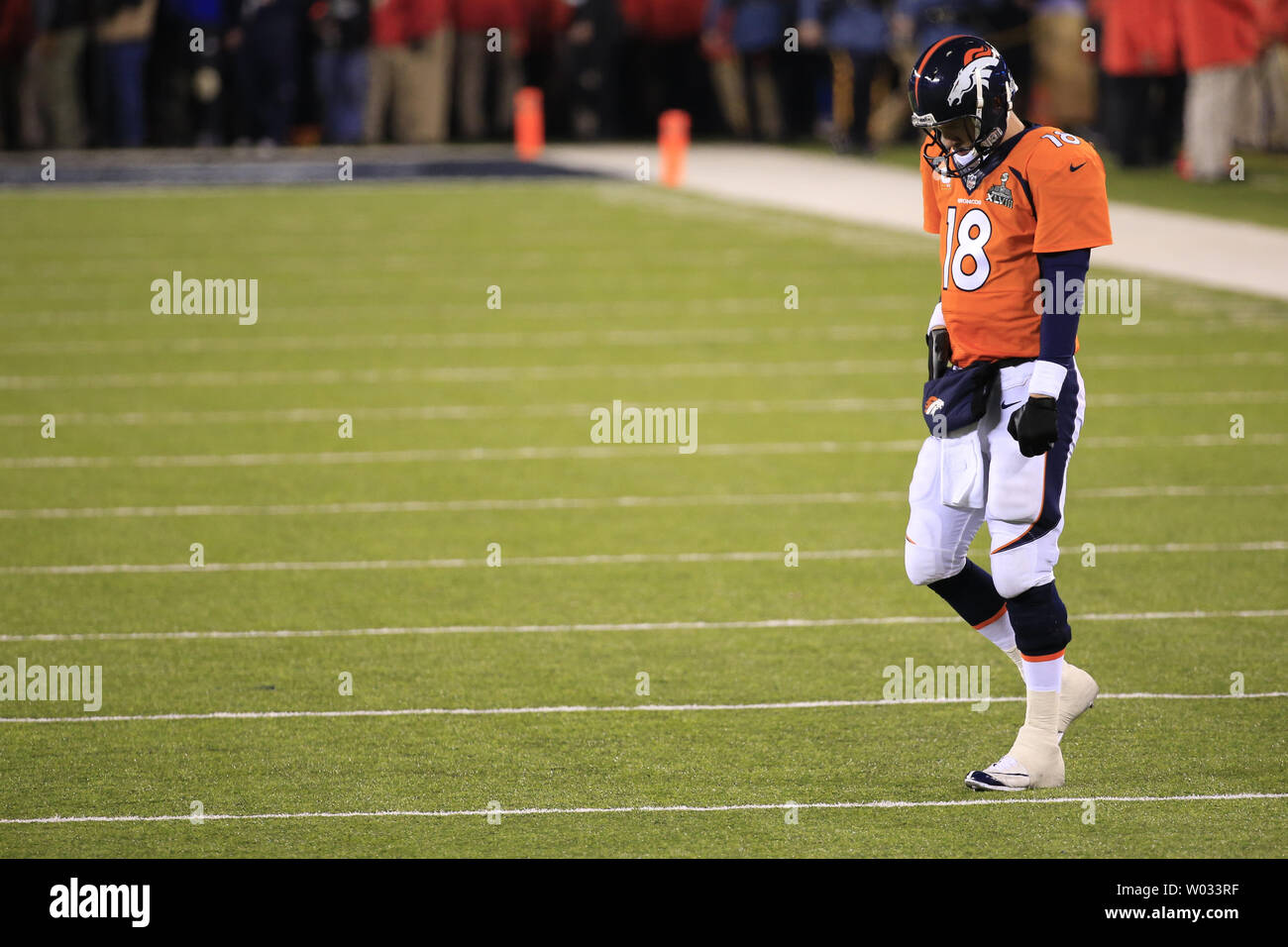 Denver Broncos quarterback Peyton Manning (18) hangs his head as he heads  back onto the field against the Seattle Seahawks at the Super Bowl XLVIII  at MetLife Stadium in East Rutherford, New