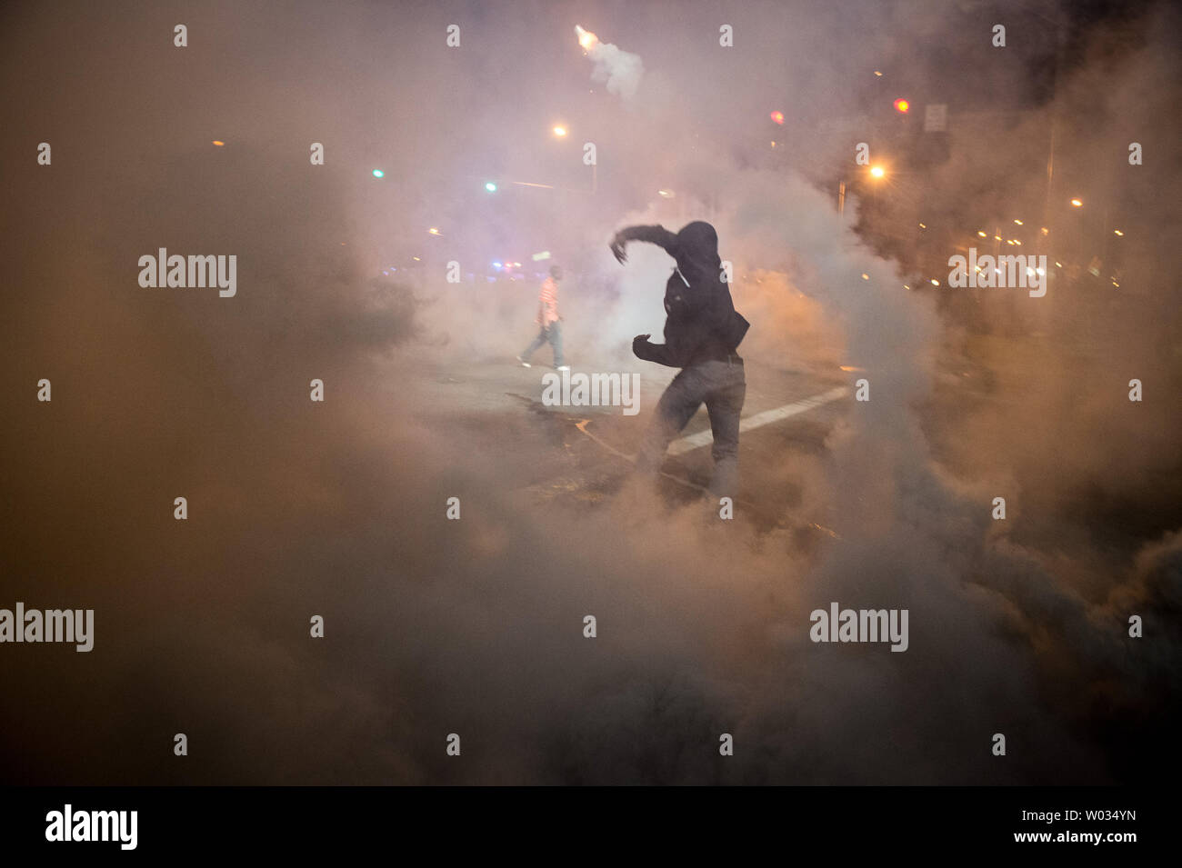 Tear gas is used during demonstrations in Baltimore, Maryland after the 10 p.m. curfew passed on April 28, 2015.  Protests have erupted after death of Freddie Gray. Photo by Ken Cedeno/UPI. Stock Photo